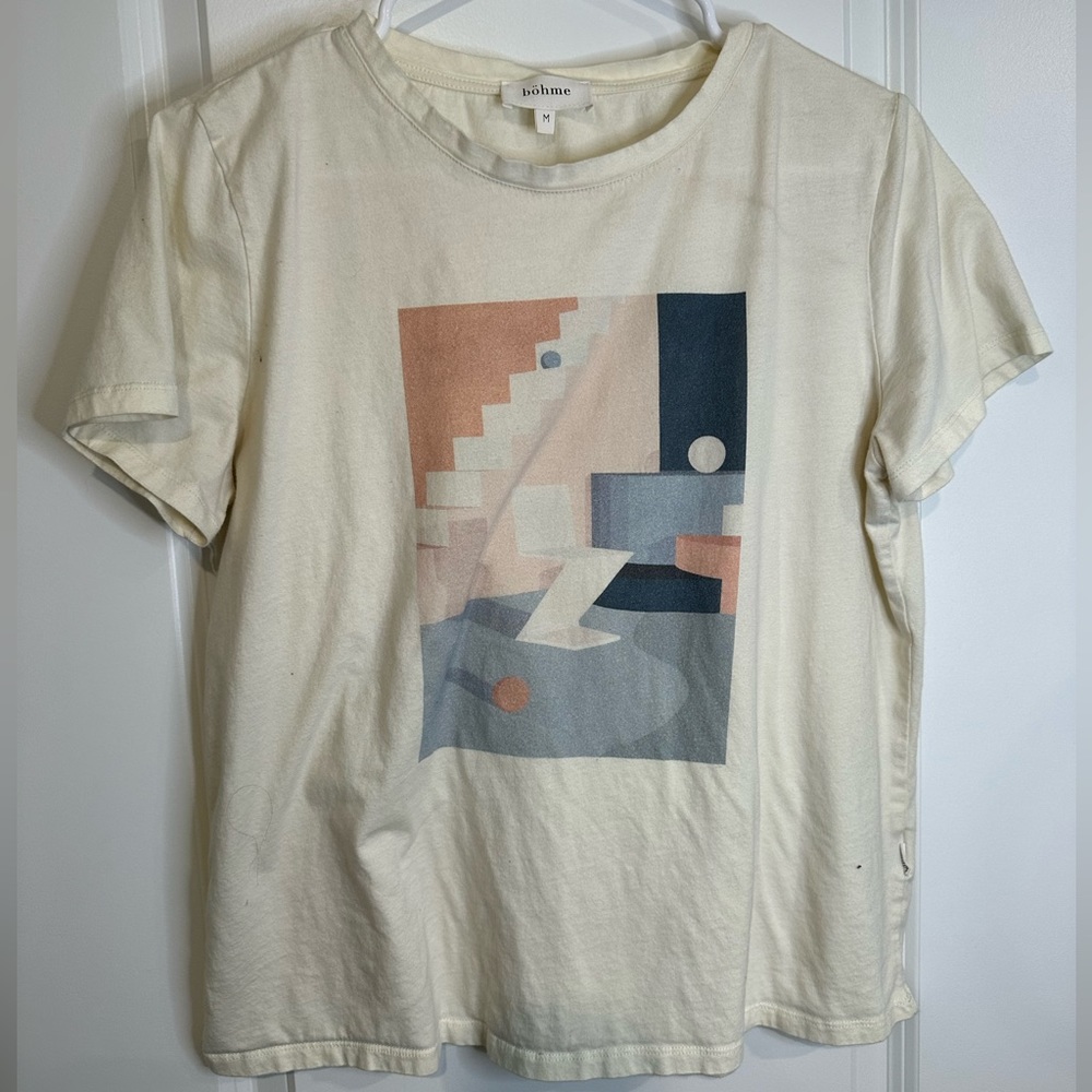Cream teeshirt with abstract design. Lightly worn